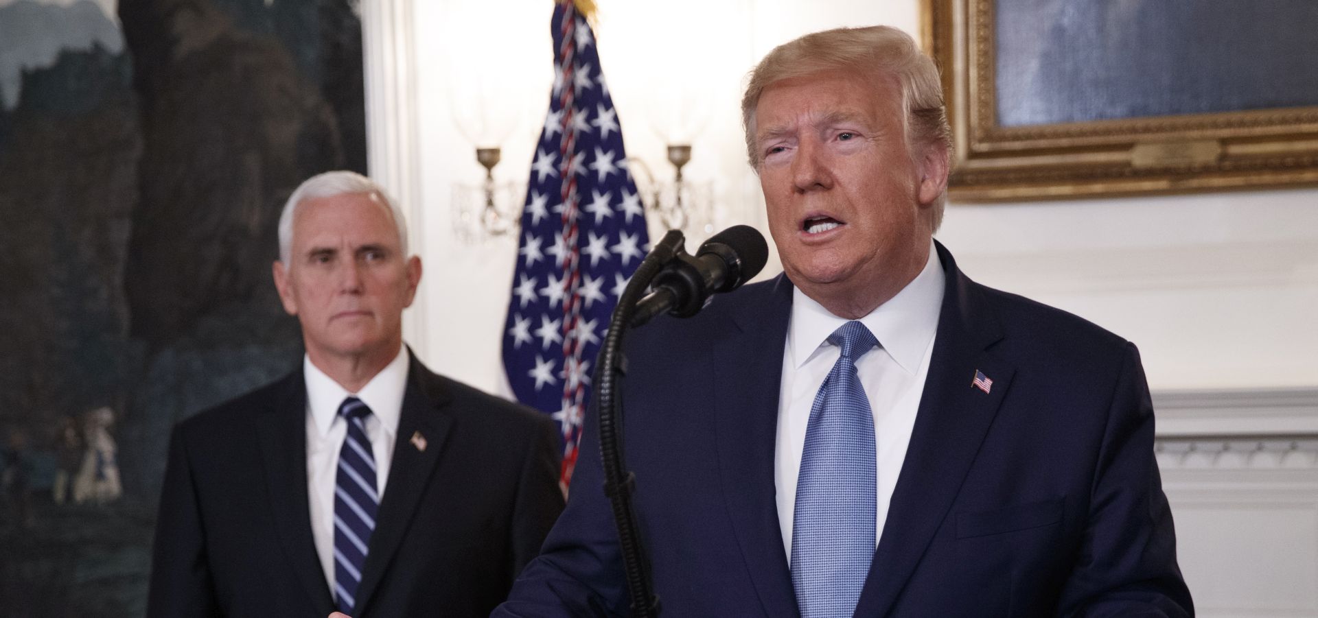 epa07943464 US President Donald J. Trump (R), with Vice President Mike Pence (L), announces the lifting of sanctions on Turkey during a statement in the Diplomatic Reception Room of the White House in Washington, DC, USA, 23 October 2019. President Trump said the US will lift the October 14th sanctions on Turkey after their offensive against the Kurds in Syria calling the cease fire permanent.  EPA/SHAWN THEW