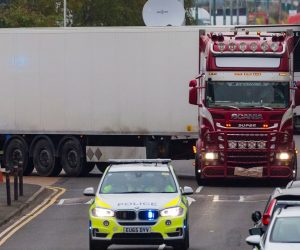 epaselect epa07943573 Police drive the lorry container along the road from the scene in Waterglade Industrial Park in Grays, Essex, Britain, 23 October 2019. A total of 39 bodies were discovered inside a lorry container in the early hours of this morning, and pronounced dead at the scene.  EPA/VICKIE FLORES