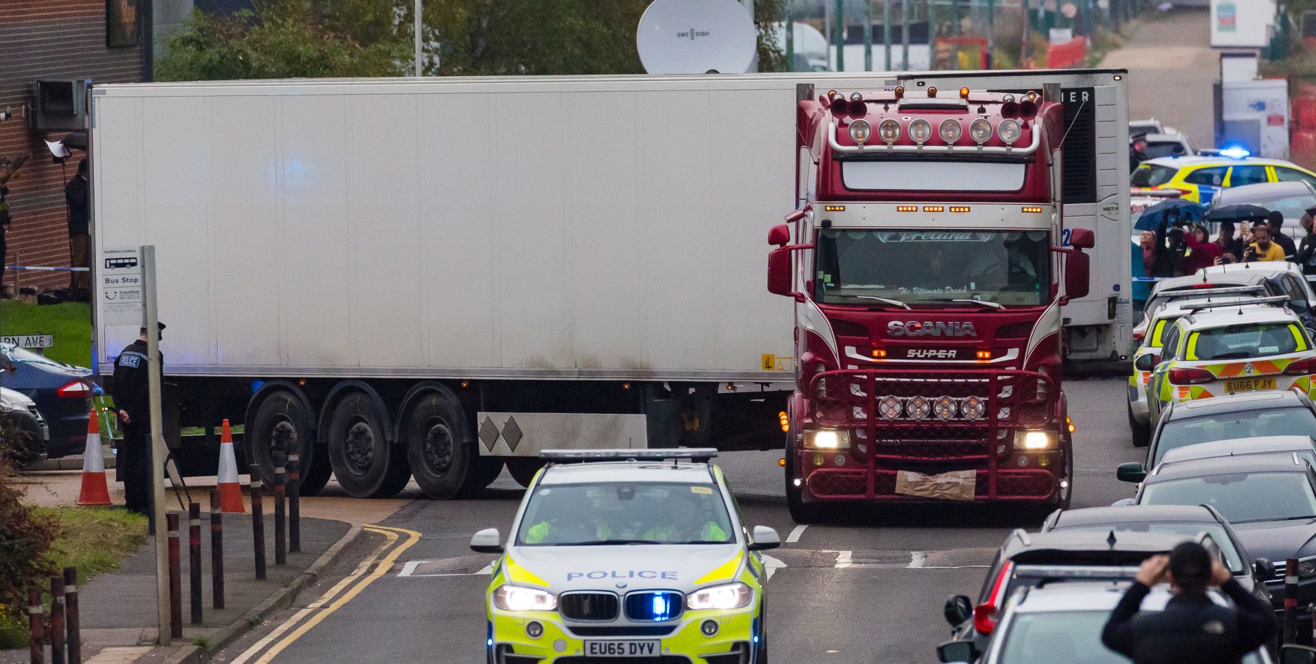 epaselect epa07943573 Police drive the lorry container along the road from the scene in Waterglade Industrial Park in Grays, Essex, Britain, 23 October 2019. A total of 39 bodies were discovered inside a lorry container in the early hours of this morning, and pronounced dead at the scene.  EPA/VICKIE FLORES