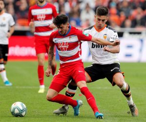 epa07983969 Valencia CF's midfielder Ferran Torres (R) duels for the ball with Granada CF's defender Carlos Neva (L) during their Spanish LaLiga Primera Division soccer match played at the Mestalla stadium in Valencia, eastern Spain, 09 November 2019.  EPA/Kai Foersterling