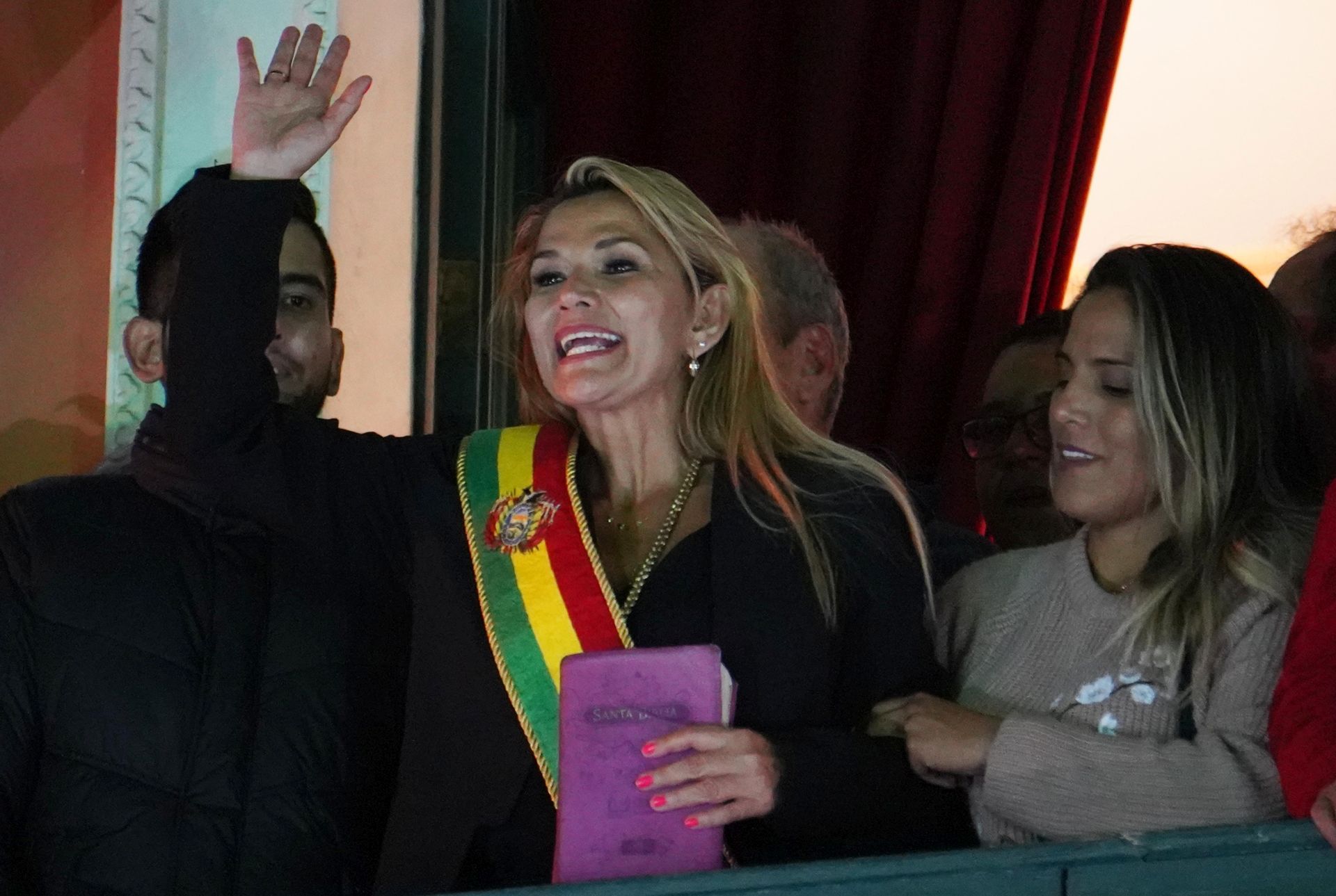 epa07992043 Opposition Senator Jeanine Anez (C) greets supporters after assuming the interim Presidency of Bolivia after the resignation and exile of former president of Evo Morales, in La Paz, Bolivia, 12 November 2019. According to media reports, Morales, the first indigenous president of this majority indigenous Andean nation, maintains that his late surge in the balloting in the 20 October elections came after votes from remote rural areas were counted. Amid pressure from violent protests Morales agreed to an audit of the votes by the Organization of American States (OAS), which found that there had been 'clear manipulation' of the vote counting process and stated a new election should be held.  EPA/STRINGER