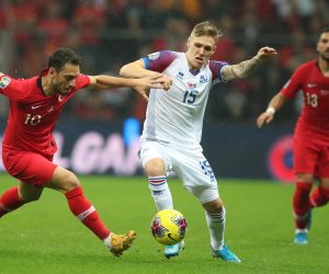 epa07996322 Turkey's Hakan Calhanoglu (L) in action against Iceland's Amor Sigurdsson (R) during the UEFA Euro 2020 qualifier Group H soccer match between Turkey and Iceland in Istanbul, Turkey, 14 November 2019.  EPA/TOLGA BOZOGLU
