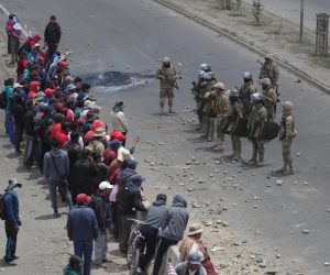 epa08009332 People takes part in protests in El Alto, Bolivia 19 November 2019. Police and military dispersed protesters protesting against the interim government of Jeanine Áñez in El Alto at the Senkata region half an hour from La Paz, Bolivia. The banner reads 'Áñez murderer'  EPA/Rodrigo Sura