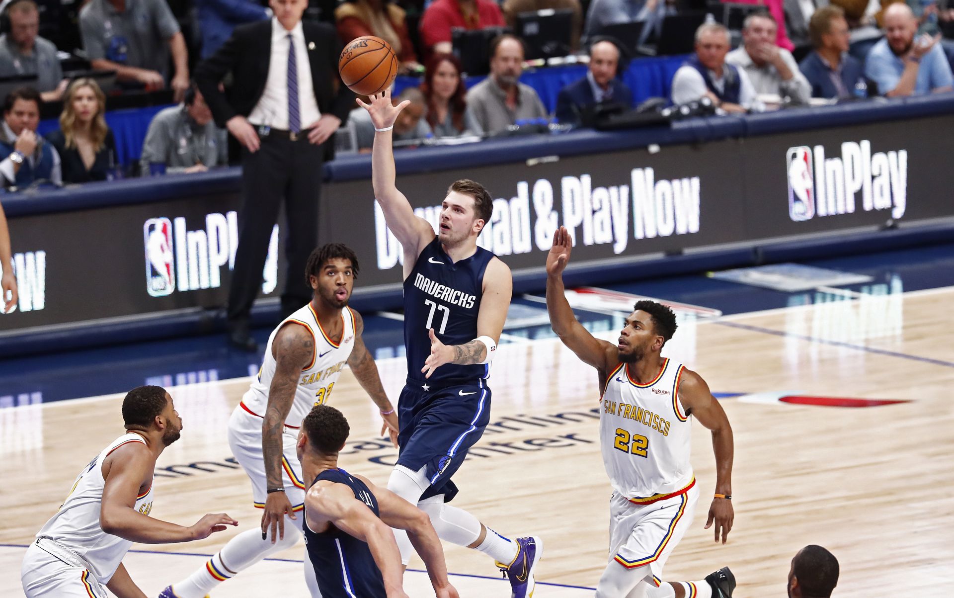 epaselect epa08013203 Dallas Mavericks player Luka Doncic (C) of Slovenia goes to the basket against the Golden State Warriors in the first half of their NBA basketball game at the American Airlines Center in Dallas, Texas, USA, 20 November 2019.  EPA/LARRY W. SMITH  SHUTTERSTOCK OUT