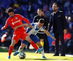 epa08021859 Getafe FC's midfielder David Remesegueiro (L) fights for the ball with midfielder Adria Giner Pedrosa (R) of RCD Espanyol during their LaLiga match between Getafe FC and RCD Espanyol played at Cornella stadium in Barcelona, Catalonia on 24 November 2019.  EPA/Enric Fontcuberta