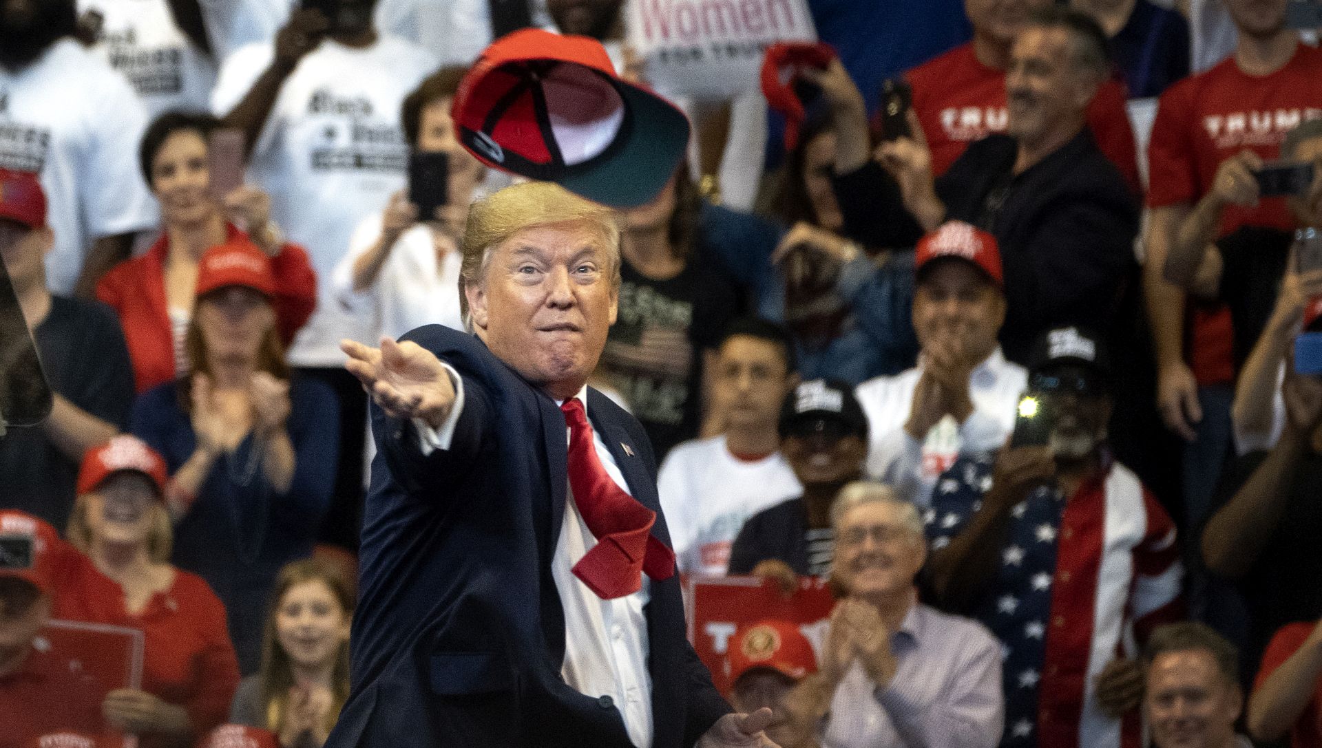 epaselect epa08028057 US President Donald J. Trump throws a 'Keep America Great' (KAG) cap at the crowd during a campaign rally at the BB&T Center in Sunrise, Florida, USA, 26 November 2019.  EPA/CRISTOBAL HERRERA