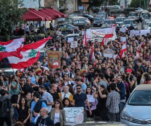 epa08037553 Protesters carry placards against sectarianism and shout slogans against the civil war during an anti-government protest as they march from Beirut Museum toward Martyr Square in Beirut, Lebanon, 01 December 2019. Protests in Lebanon are continuing since first erupted on 17 October, as protesters aim to apply pressure on the country's political leaders over what they view as a lack of progress following the prime minister's resignation on 29 October.  EPA/NABIL MOUNZER