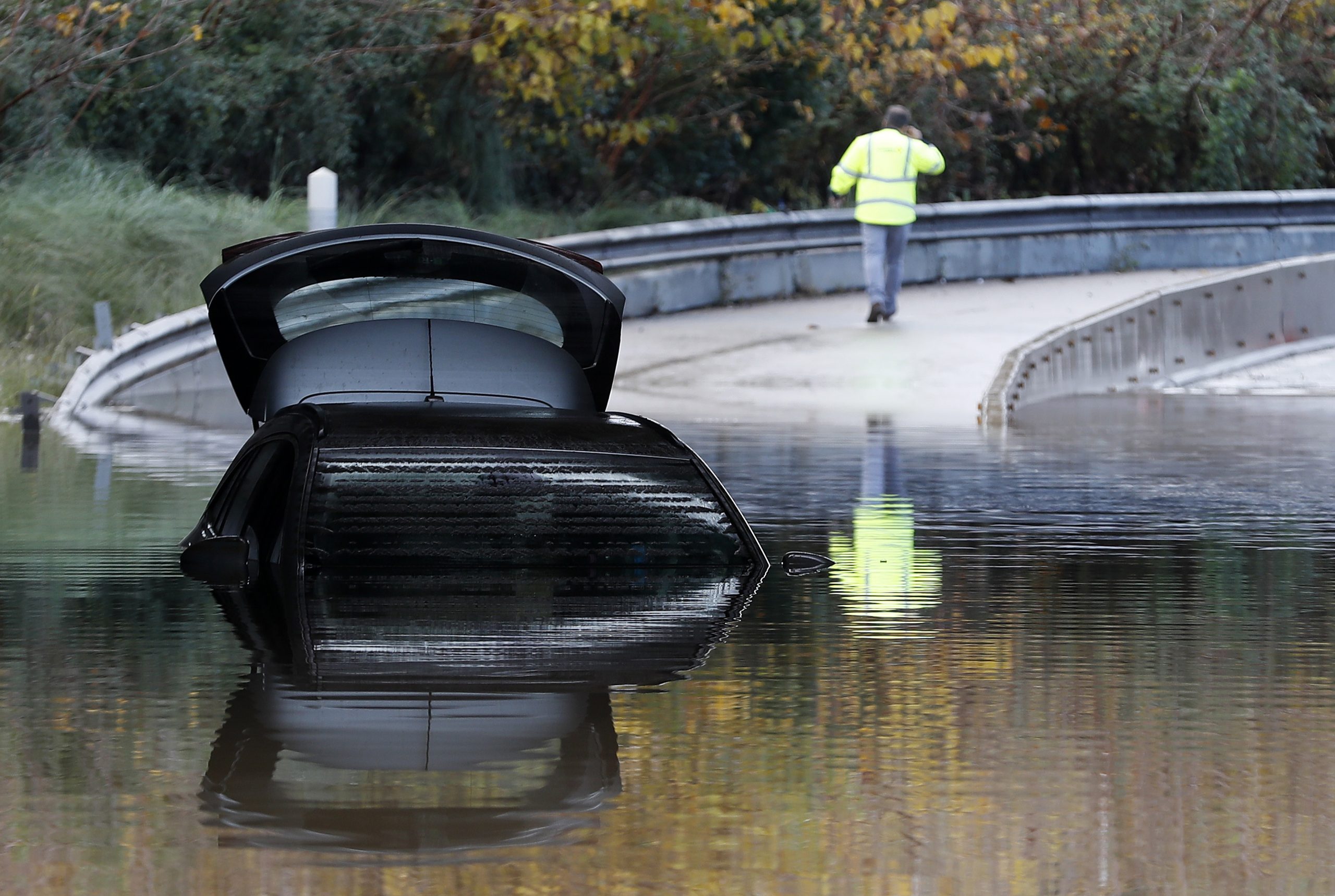 epa08039300 A submerged car remains in the middle of a flooded street after heavy rainfalls that hit Alpes-Maritimes department overnight in Mandelieu, France, 02 December 2019.  EPA/SEBASTIEN NOGIER