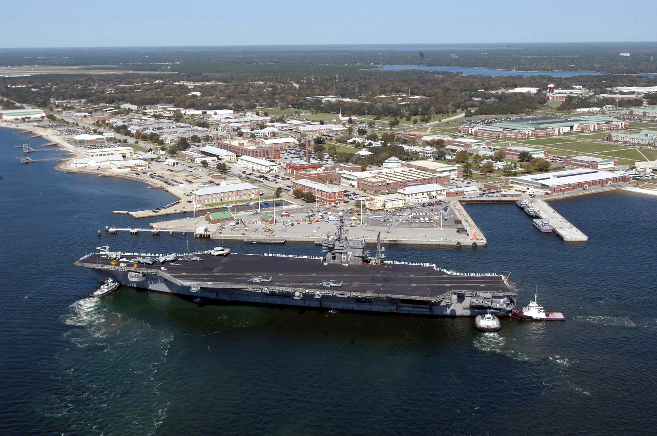 epa08050894 (FILE) - A handout file photo made available by the US Navy shows an aerial view of the USS John F. Kennedy (CV 67) arriving for a port visit at Naval Air Station (NAS) Pensacola, in Pensacola, Florida, USA, 17 March 2004 (issued 07 December 2019). Media reports state that a gunman on 06 December 2019 opened fire inside the Naval Air Station Pensacola killing three people and injuring at least eight others. The attacker, identified as a member of the Saudi Air Force and an aviation student at the base who had been in the country since August 2017, was shot dead by authorities, media added. Officials have not yet determined a motive for the shooting.  EPA/US NAVY/PATRICK NICHOLSs HANDOUT  HANDOUT EDITORIAL USE ONLY/NO SALES
