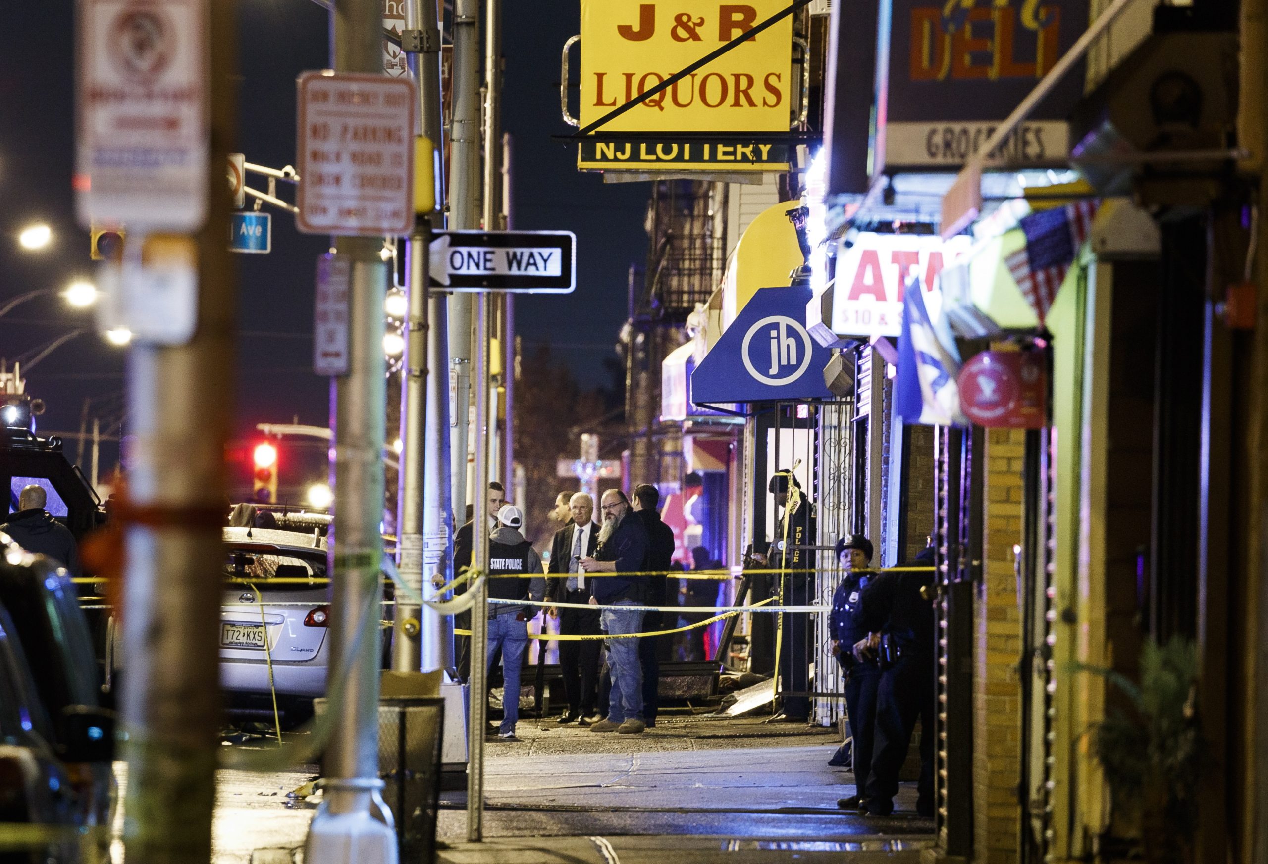 epa08061520 Police secure and investigate the scene of a multiple shooting in Jersey City, New Jersey, USA, 10 December 2019. Six people were killed, including the two shooters and a police officer, earlier on the same day when two men shot a police officer in an area cemetery and then had a shootout with police from inside a kosher supermarket.  EPA/JUSTIN LANE