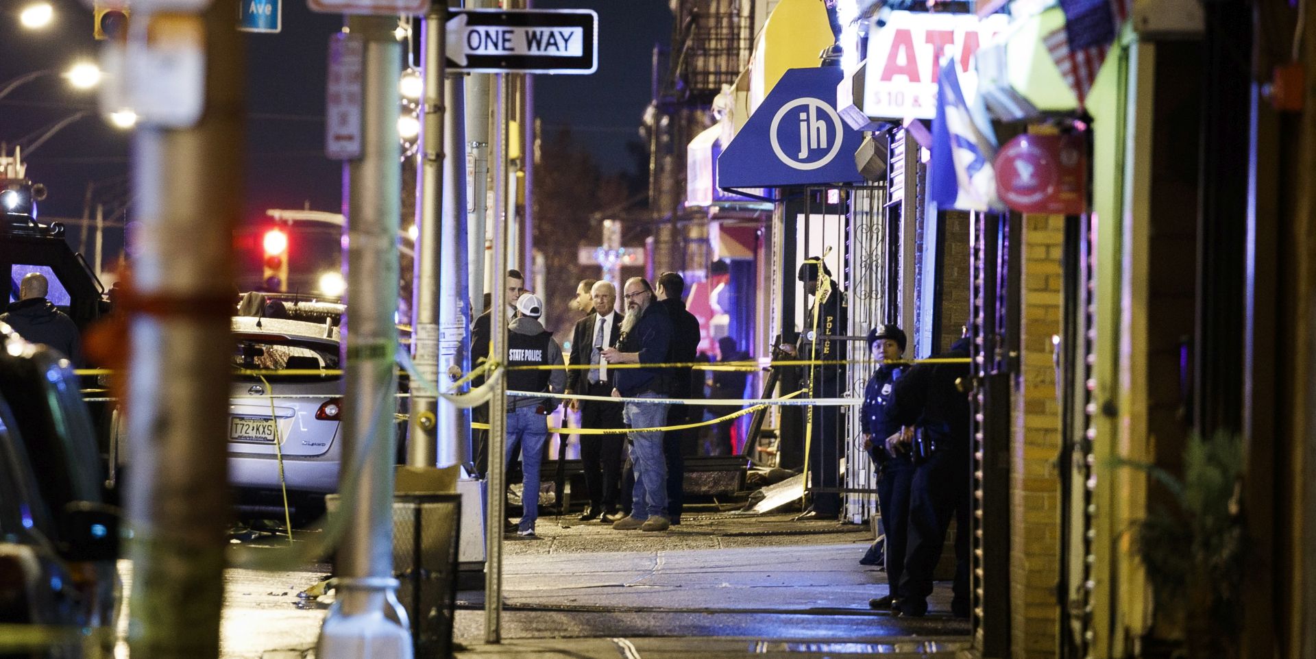 epa08061520 Police secure and investigate the scene of a multiple shooting in Jersey City, New Jersey, USA, 10 December 2019. Six people were killed, including the two shooters and a police officer, earlier on the same day when two men shot a police officer in an area cemetery and then had a shootout with police from inside a kosher supermarket.  EPA/JUSTIN LANE