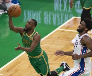 epaselect epa08067479 Boston Celtics guard Kemba Walker (L) shoots past defending Philadelphia 76ers center Joel Embiid (R) during the second half of the NBA basketball game between the Philadelphia 76ers and the Boston Celtics at the TD Garden in Boston, Massachusetts, USA, 12 December 2019.  EPA/CJ GUNTHER SHUTTERSTOCK OUT