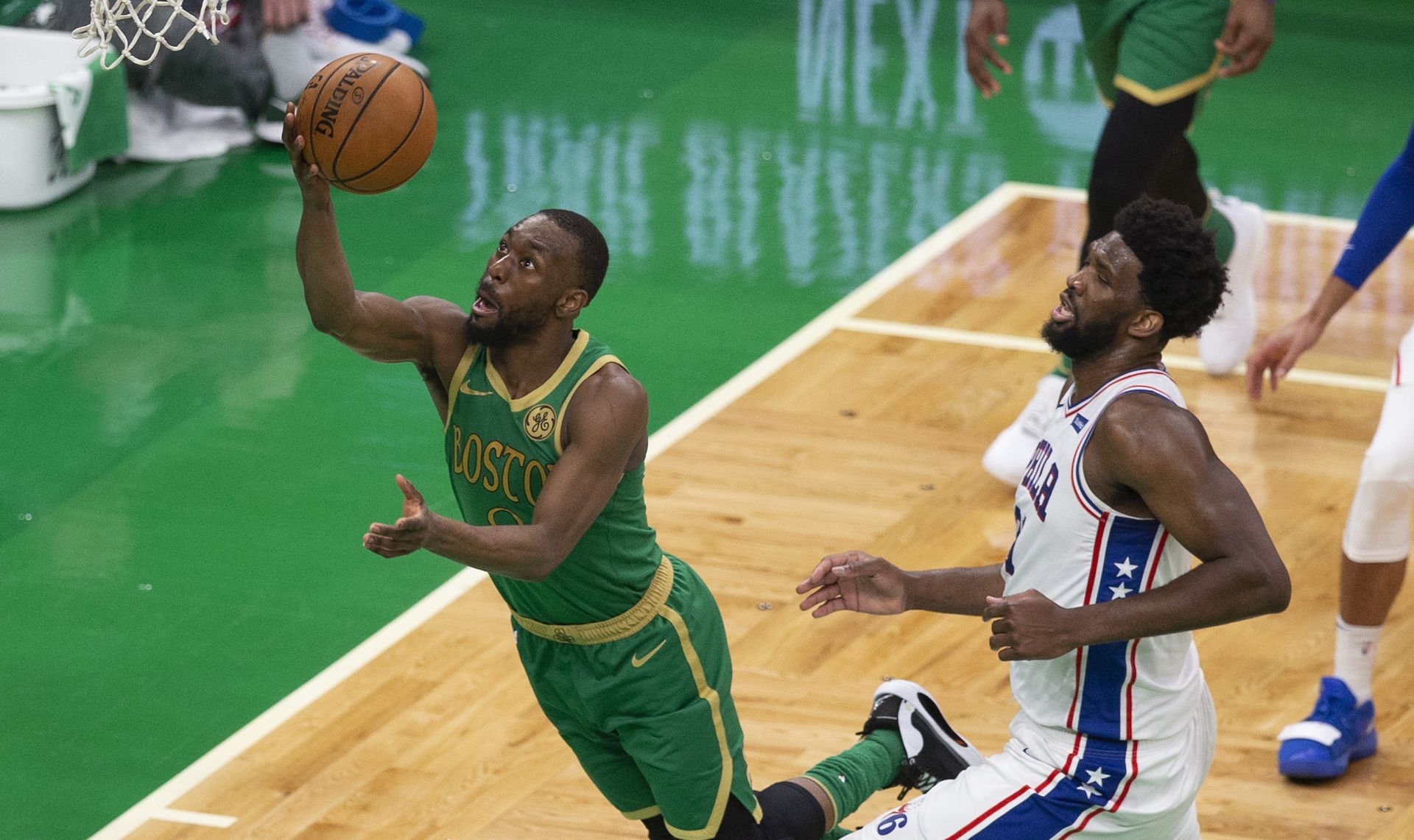 epaselect epa08067479 Boston Celtics guard Kemba Walker (L) shoots past defending Philadelphia 76ers center Joel Embiid (R) during the second half of the NBA basketball game between the Philadelphia 76ers and the Boston Celtics at the TD Garden in Boston, Massachusetts, USA, 12 December 2019.  EPA/CJ GUNTHER SHUTTERSTOCK OUT