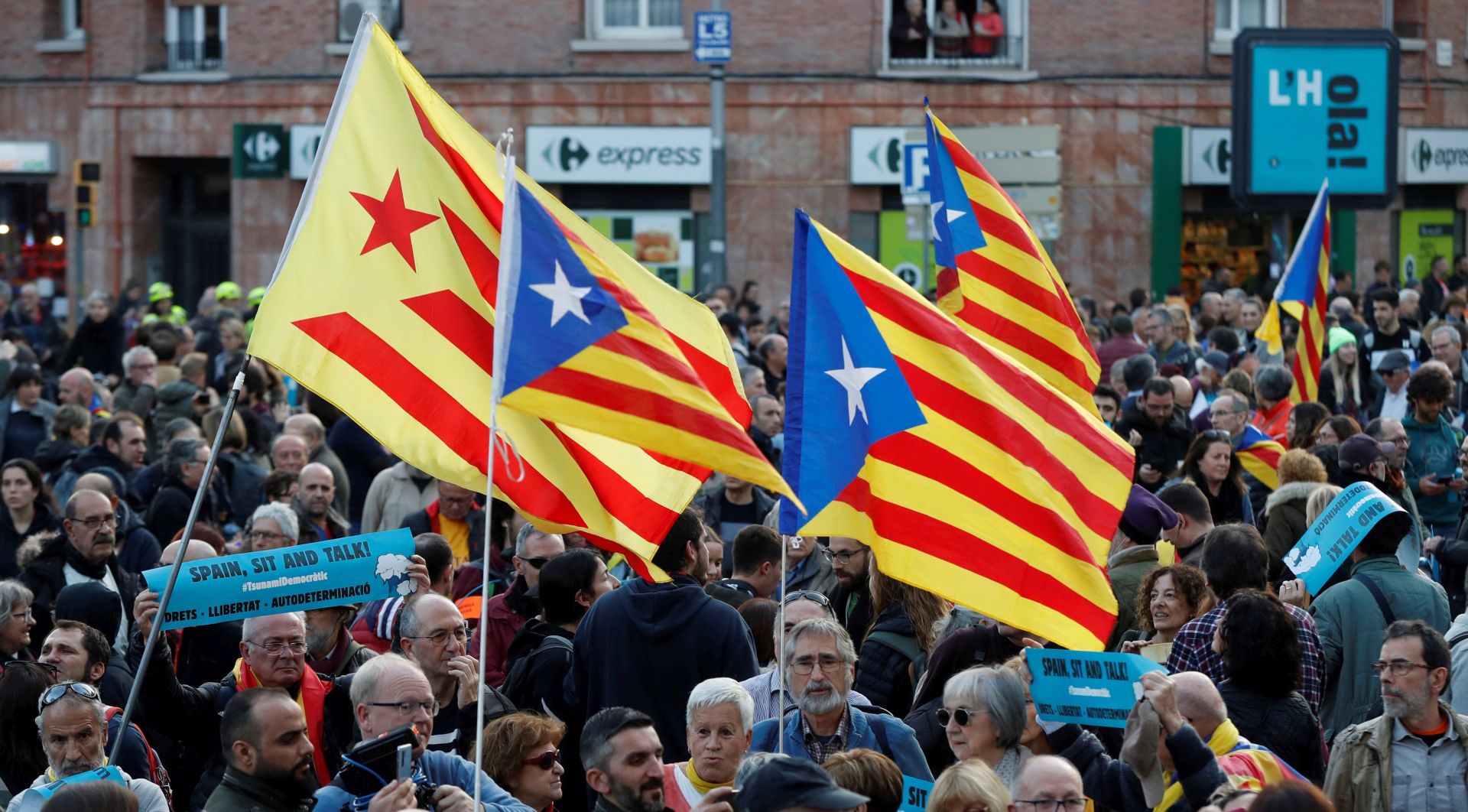 epa08079531 People attend a protest called for by the pro-Catalan independence initiative 'Tsunami Democratic' near the Camp Nou stadium in Barcelona, Spain, 18 December 2019, ahead of a Spanish LaLiga soccer match between FC Barcelona and Real Madrid at the Camp Nou stadium. Barcelona will face Real Madrid in their Spanish LaLiga soccer match, initially scheduled for 26 October 2019.  EPA/TONI ALBIR
