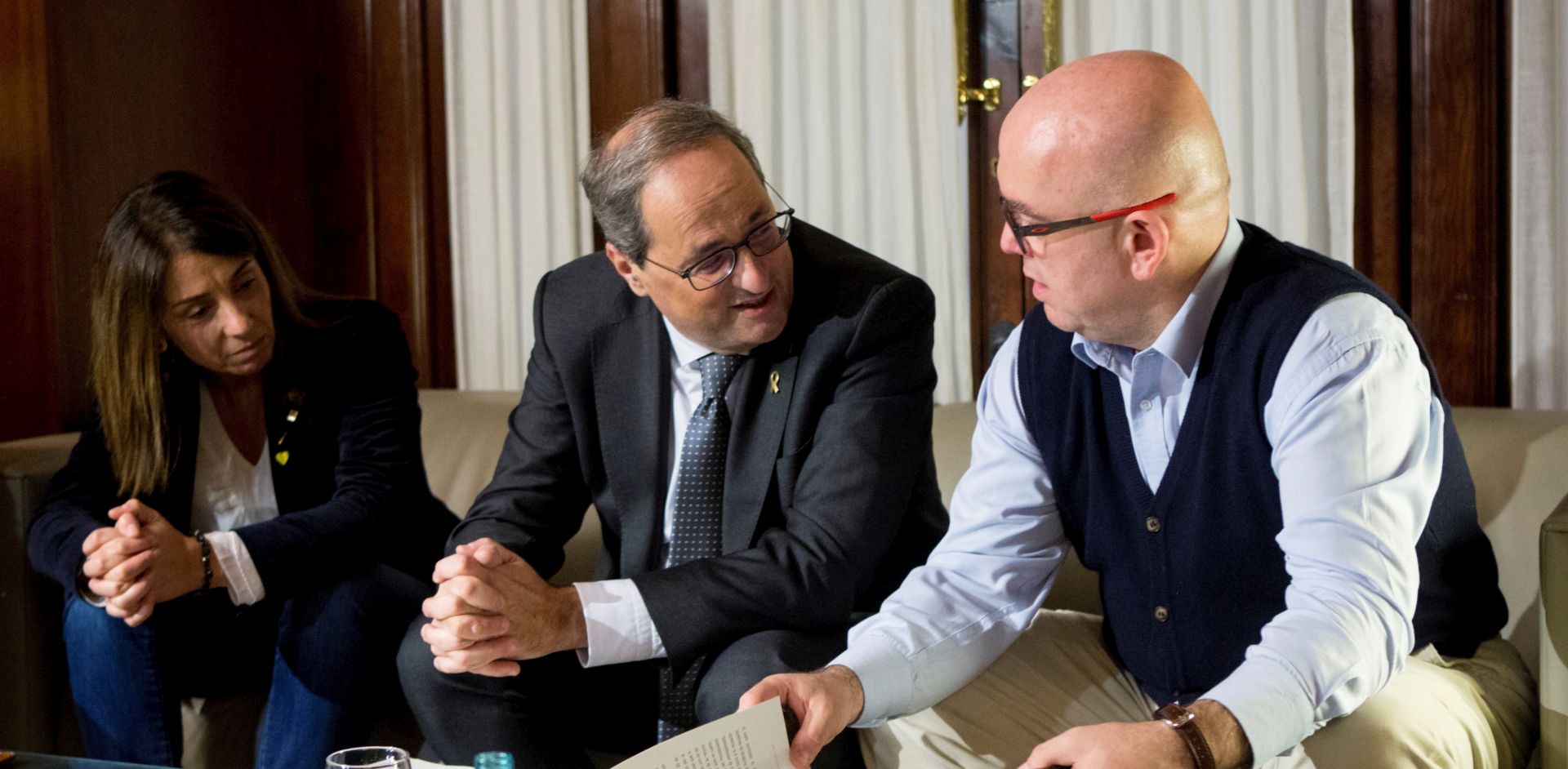 epa08081636 Catalan regional President Quim Torra (C) chats with Catalan regional Government spokeswoman, Meritxell Budo (L), and his lawyer Gonzalo Boye (R), in Barcelona, Spain, 19 December 2019. Torra has been suspended for 18 months on 19 December 2019 from all public duties, for disobeying the order, ruled by Spanish Election Commission, of removing the yellow ribbons, symbol of supporting Catalan imprisoned politicians, during the election campaign for general elections 28 April 2019, Catalonia Higher Justice Court announced.  EPA/QUIQUE GARCIA