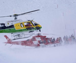 epa08090919 Rescue forces and helicopters search for missing persons after an avalanche swept down a ski piste in the central town of Andermatt in canton Uri, Switzerland, Switzerland, 26 December 2019. Six people have been rescued, two of them with minor injuries but cantonal authorities fear that several other people may be buried. An extensive rescue operation is underway.  EPA/Urs Flueeler
