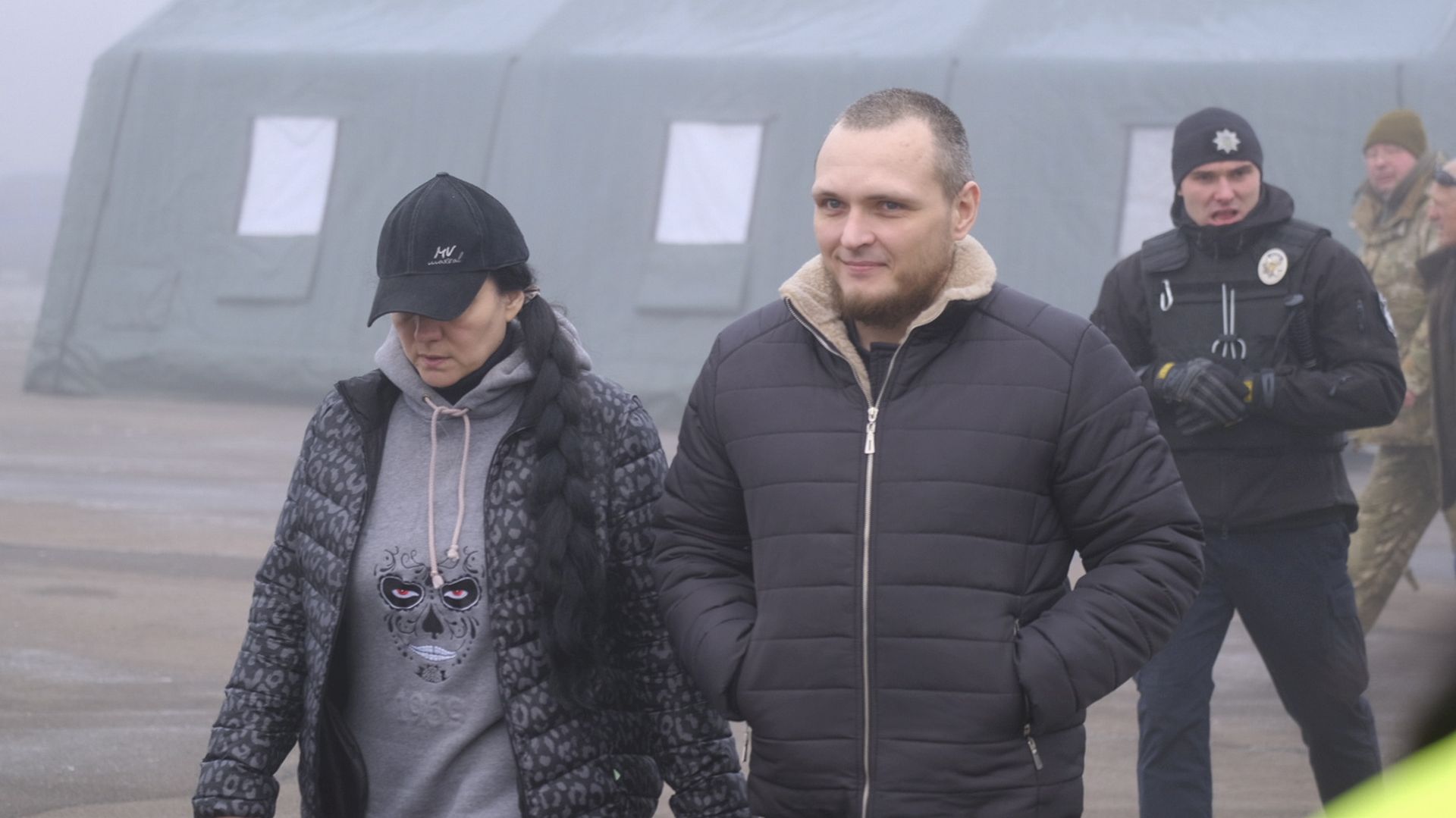 epa08093466 Prisoners walk towards busses before a prisoner exchange between Ukrainian and pro-Russian rebels' sides, not far from the Maiorske checkpoint, Donetsk area, Ukraine, 29 December 2019. According to media reports, the Ukrainian side will swap prisoners who were captured in Ukrainian-controlled territory for Ukrainian citizens, including prisoners of war (POW) that were held hostages in occupied Donbas at the Maiorske crossing checkpoint, on the contact line between the warring parties near the pro-Russian militant-occupied town of Horlivka in Donetsk region. The agreement, reached during the summit of the Normandy Four leaders in Paris on 09 December 2019, sets the exchange between Kyiv and Donbas to be carried out before the end of the year.  EPA/YEVGEN HONCHARENKO