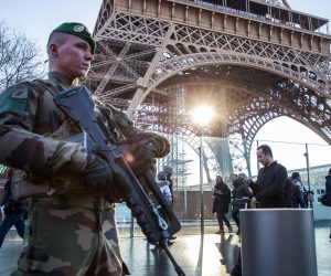 epa08094804 A French soldier from the 'Sentinelle military Operation' stands guard as Interior Minister Castaner  (unseen) visits the security forces securing the Eiffel Tower  to discuss New Year holiday security measures in Paris, France, 30 December 2019.  EPA/CHRISTOPHE PETIT TESSON
