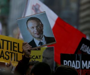 Demonstration to demand justice over the murder of journalist Daphne Caruana Galizia in Valetta A protester holds a picture of Maltese Prime Minister Joseph Muscat with his face covered in blood, next to a person holding a sign during a demonstration demanding justice over the murder of journalist Daphne Caruana Galizia outside the Parliament House, in Valletta, Malta, December 1, 2019. The sign reads, "Murderers in Castille" REUTERS/Darrin Zammit Lupi NO RESALES. NO ARCHIVES DARRIN ZAMMIT LUPI