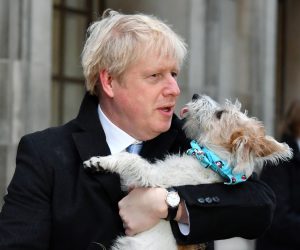 Britain's general election 2019 Britain's Prime Minister Boris Johnson holds his dog Dilyn as leaves a polling station, at the Methodist Central Hall, after voting in the general election in London, Britain, December 12, 2019. REUTERS/Dylan Martinez DYLAN MARTINEZ