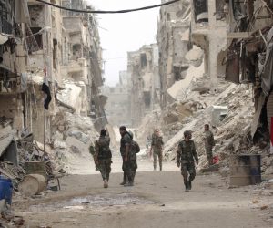 epa08095884 PICTURES OF THE DECADE 

Syrian soldiers patrol at the Yarmouk Camp district in south Damascus, Syria, 22 May 2018.  EPA/YOUSSEF BADAWI *** Local Caption *** 54689621