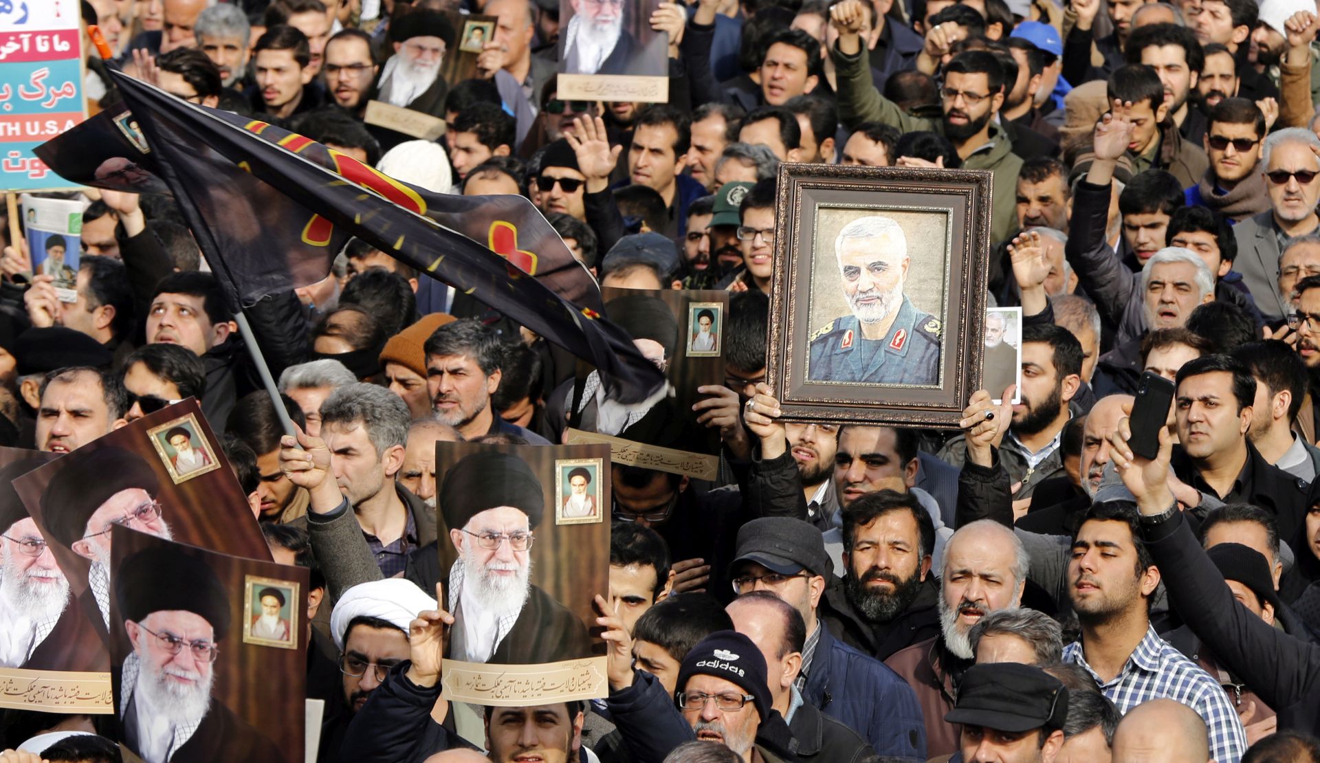 epa08099832 Iranians holding pictures of Supreme Leader Ali Khamenei and of Iranian Revolutionary Guards Corps (IRGC) Lieutenant general and commander of the Quds Force Qasem Soleimani take to the streets during an anti-US demonstration to condemn the killing of Soleimani, after Friday prayers in Tehran, Iran, 03 January 2020. The Pentagon announced that Iran's Quds Force leader Qasem Soleimani and Iraqi militia commander Abu Mahdi al-Muhandis were killed on 03 January 2020 following a US airstrike at Baghdad's international airport. The attack comes amid escalating tensions between Tehran and Washington.  EPA/ABEDIN TAHERKENAREH