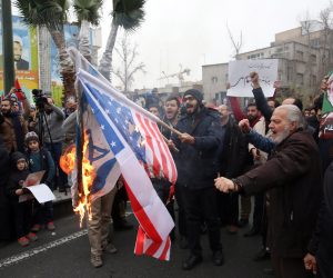 epa08102256 
Iranians burn US and Israel flags during anti-US protests over killing late Iranian Revolutionary Guards Corps (IRGC) Lieutenant general and commander of the Quds Force Qasem Soleimani  in Tehran, Iran, 04 January 2020. The Pentagon announced that Iran's Quds Force leader Qasem Soleimani and Iraqi militia commander Abu Mahdi al-Muhandis were killed on 03 January 2020 following a US airstrike at Baghdad's international airport. The attack comes amid escalating tensions between Tehran and Washington  EPA/ABEDIN TAHERKENAREH