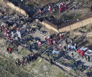 epaselect epa08111625 An areal view from a helicopter shows a general view of the crash site as members of emergency services workers and members of the International Red Crescent work next to the wreckage after an Ukraine International Airlines Boeing 737-800 carrying 176 people crashed near Imam Khomeini Airport in Tehran, killing everyone on board; in Shahriar, Iran, 08 January 2020.  EPA/RUHOLLAH VAHDATI