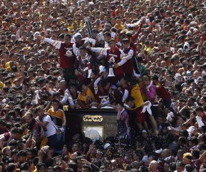epa08113511 The Black Nazarene is taken on a procession as Catholic devotees flock around to mark its feast day in Manila, Philippines, 09 January 2020. The feast of the Black Nazarene is one of the most celebrated religious events in the predominantly Catholic Philippines, where more than 80 percent of the population professes the faith. The wooden statue, crowned with thorns and bearing a cross, is believed to have been brought from Mexico to Manila in 1606 by Spanish missionaries. The ship that carried it caught fire, but the charred statue survived and was named the Black Nazarene.  EPA/ROLEX DELA PENA