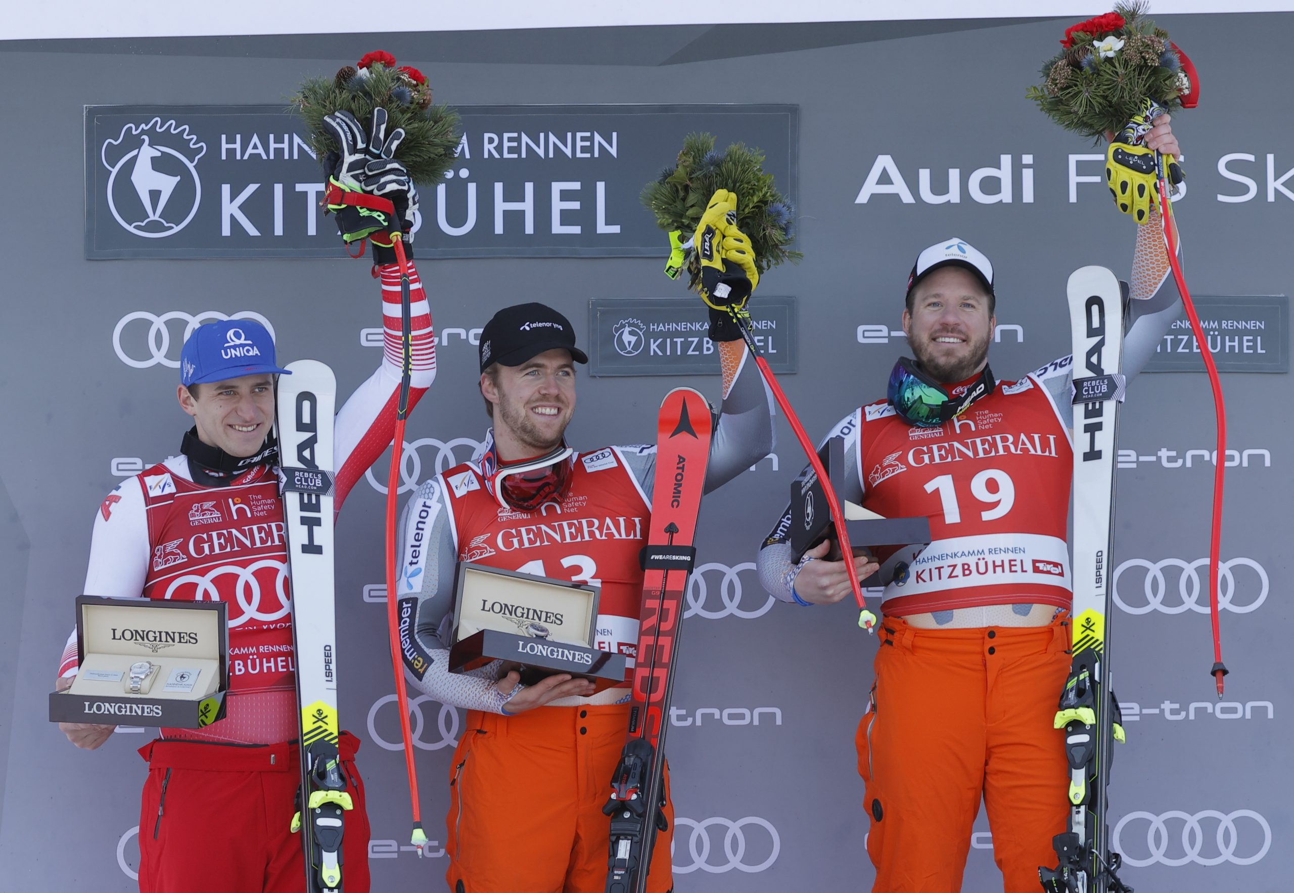epa08159587 Winner Kjetil Jansrud of Norway (R) joined by second placed Matthias Mayer of Austria (L) and Aleksander Aamodt of Norway (C) pose on the podium after the men's Super G race of the FIS Alpine Skiing World Cup event in Kitzbuehel, Austria, 24 January 2020.  EPA/VALDRIN XHEMAJ