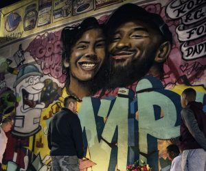 epa08171710 Fans pay their respect at a makeshift memorial in front of a mural by the artists Mr79lts and Muck Rock showing Kobe Bryant and his daughter Gianna Bryant on a wall of the Pickford Market in Los Angeles, California, USA, 27 January 2020. Former US basketball player Kobe Bryant, his daughter Gianna, and seven others have died in a helicopter crash in Calabasas, California, USA on 26 January 2020. He was 41.  EPA/ETIENNE LAURENT