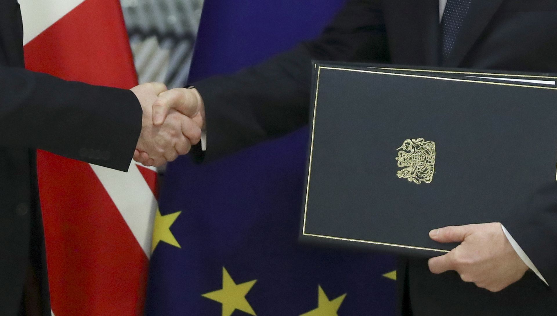 epa08174689 Permanent Representative of the United Kingdom to the European Union, Tim Barrow (L, out of frame) delivers the instruments of ratification for Brexit, to European Council Secretary General Jeppe Tranholm-Mikkelsen at the EU Council headquarters in Brussels, Belgium, 29 January 2020. Britain's withdrawal from the EU is set for midnight CET on 31 January 2020, with the European Parliament scheduled to vote on the Brexit Withdrawal Agreement on 29 January.  EPA/YVES HERMAN / POOL