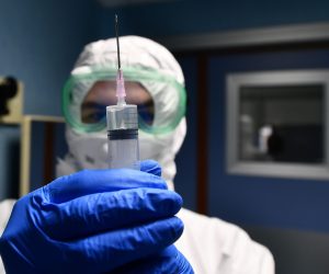 epa08179914 Medical staff of S. Martino hospital infectious disease department, with protective equipment on the isolation room, Genoa, Italy, 30 January 2020. The coronavirus, called 2019-nCoV, originating from Wuhan, China, has spread to all the 31 provinces of China as well as more than a dozen countries in the world. The outbreak of coronavirus has so far claimed at least 170 lives and infected more than 8,000 others, according to media reports.  EPA/LUCA ZENNARO
