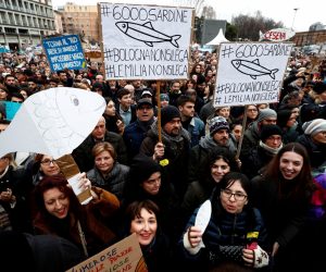 Protesters attend a demonstration held by "the sardines", a grassroots movement against far-right League leader Matteo Salvini, in Bologna Supporters of "the sardines", a grassroots movement against far-right League leader Matteo Salvini, hold placards during a demonstration in Bologna, Italy, January 19, 2020. REUTERS/Guglielmo Mangiapane Guglielmo Mangiapane