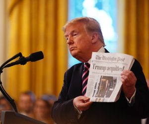 epaselect epa08198270 US President Donald J. Trump holds the front page of the Washington Post with headline 'Trump acquitted' as he speaks in the East Room of the White House a day after his Senate impeachment trial acquittal in Washington, DC, USA, 06 February 2020. Trump was found not guilty on two articles of impeachment 05 February after a two-week trial.  EPA/JIM LO SCALZO