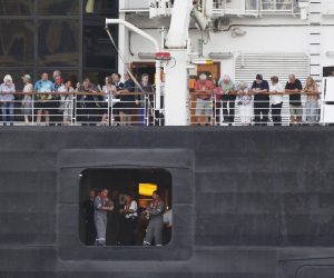 epa08214916 Passengers stand on the MS Westerdam cruise ship at a sea port in Preah Sihanouk province, Cambodia, 13 February 2020. The Cambodian government allowed the MS Westerdam cruise ship, with about 2,000 passengers and crew aboard, to dock at Preah Sihanouk port, according to local media reports. The cruise ship was denied port by four countries over unsubstantiated reports that people infected with coronavirus were onboard. The disease caused by the SARS-CoV-2 has been officially named Covid-19 by the World Health Organization (WHO). The outbreak, which originated in the Chinese city of Wuhan, has so far killed at least 1,369 people with over 60,000 infected worldwide, mostly in China.  EPA/MAK REMISSA
