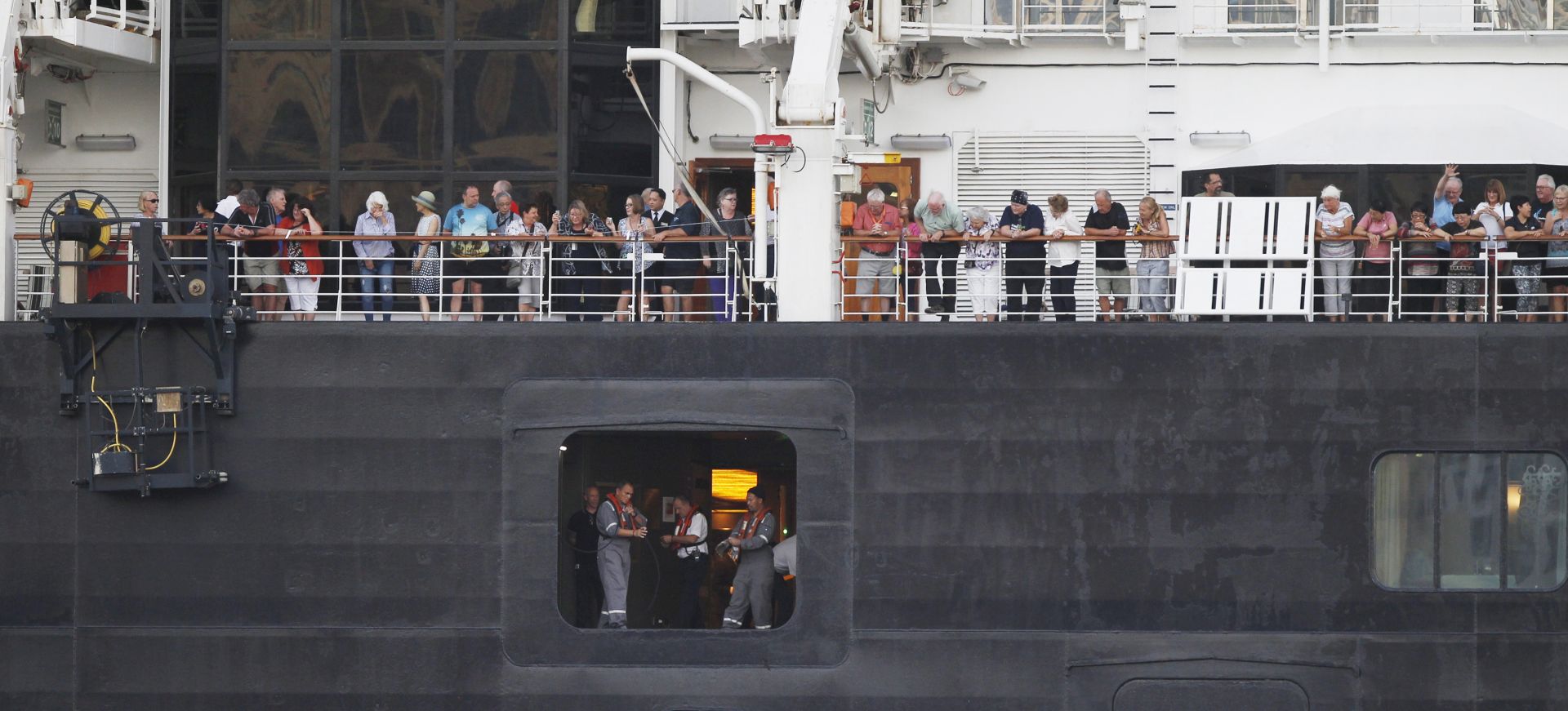 epa08214916 Passengers stand on the MS Westerdam cruise ship at a sea port in Preah Sihanouk province, Cambodia, 13 February 2020. The Cambodian government allowed the MS Westerdam cruise ship, with about 2,000 passengers and crew aboard, to dock at Preah Sihanouk port, according to local media reports. The cruise ship was denied port by four countries over unsubstantiated reports that people infected with coronavirus were onboard. The disease caused by the SARS-CoV-2 has been officially named Covid-19 by the World Health Organization (WHO). The outbreak, which originated in the Chinese city of Wuhan, has so far killed at least 1,369 people with over 60,000 infected worldwide, mostly in China.  EPA/MAK REMISSA