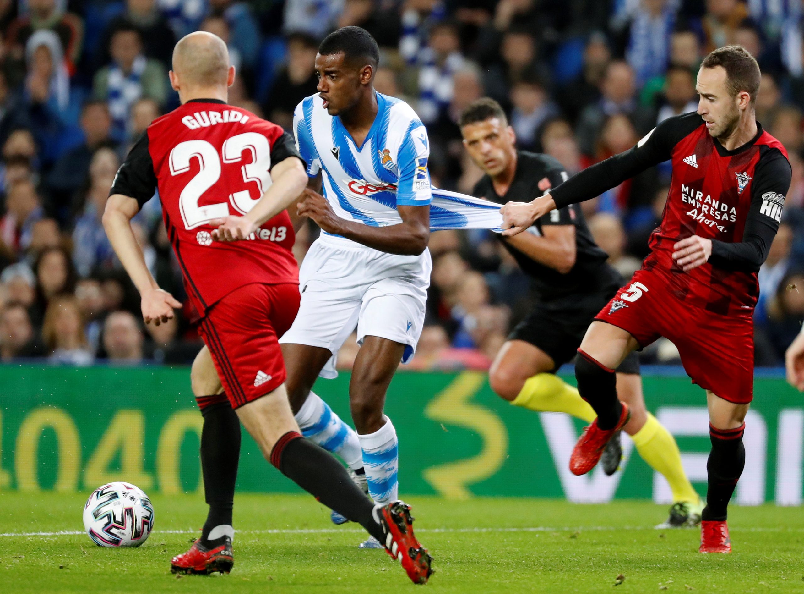 epa08216131 Real Sociedad's forward Alexander Isak (C) in action against Mirandes' defender Odei (R) during the King's Cup first leg soccer match between Real Sociedad and CD Mirandes at Reale Arena stadium in San Sebastian, Basque Country, Spain, 13 February 2020.  EPA/Juan Herrero
