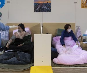 epa08217764 Medical staff attend to patients in Wuhan Fangcang hospital, a makeshift hospital to treat Covid-19 patients in Wuhan City, Hubei Province, China, 14 February 2020. The disease caused by the novel coronavirus (SARS-CoV-2) has been officially named COVID-19 by the World Health Organization (WHO). The Chinese government said 14 February that a total of 1,716 health care workers had been infected with the disease, a number much greater than those recorded during the 2003 Sars outbreak.  EPA/STRINGER CHINA OUT