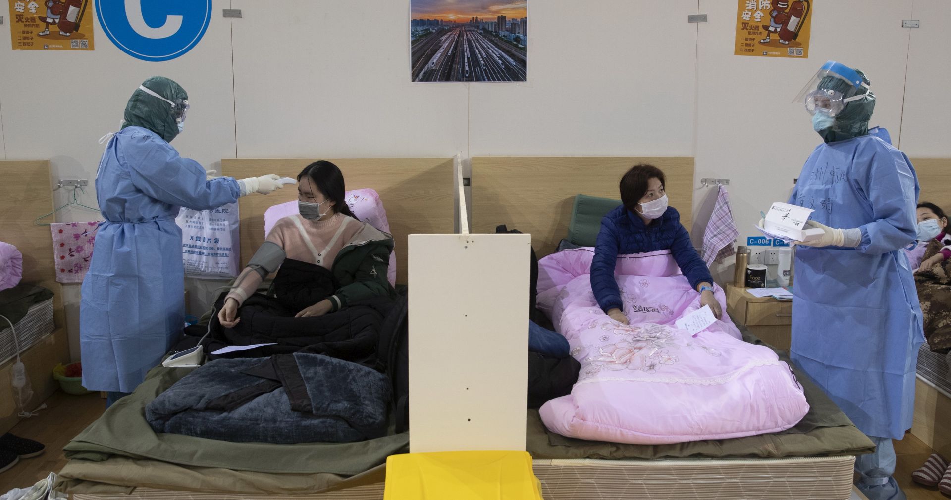 epa08217764 Medical staff attend to patients in Wuhan Fangcang hospital, a makeshift hospital to treat Covid-19 patients in Wuhan City, Hubei Province, China, 14 February 2020. The disease caused by the novel coronavirus (SARS-CoV-2) has been officially named COVID-19 by the World Health Organization (WHO). The Chinese government said 14 February that a total of 1,716 health care workers had been infected with the disease, a number much greater than those recorded during the 2003 Sars outbreak.  EPA/STRINGER CHINA OUT