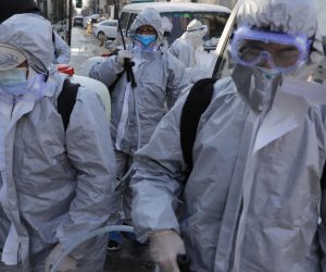 epa08219050 Workers wearing protective suits gather after they disinfected a residential area in Beijing, China, 15 February 2020. Beijing officials ordered everyone returning to the city after the holidays to go into quarantine for 14 days in order to control the spread of coronavirus. The disease caused by the novel coronavirus (SARS-CoV-2) has been officially named COVID-19 by the World Health Organization (WHO). The outbreak, which originated in the Chinese city of Wuhan, has so far killed at least 1,526 people with over 67,000 infected worldwide, mostly in China.  EPA/WU HONG
