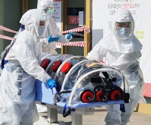 epa08227800 A patient suspected of carrying the new coronavirus, named COVID-19, arrives at Kyungpook National University Hospital in Daegu, South Korea, 19 February 2020. The city fell into chaos as 13 people residing there were found to have come down with the China-originated virus earlier in the day.  EPA/YONHAP SOUTH KOREA OUT