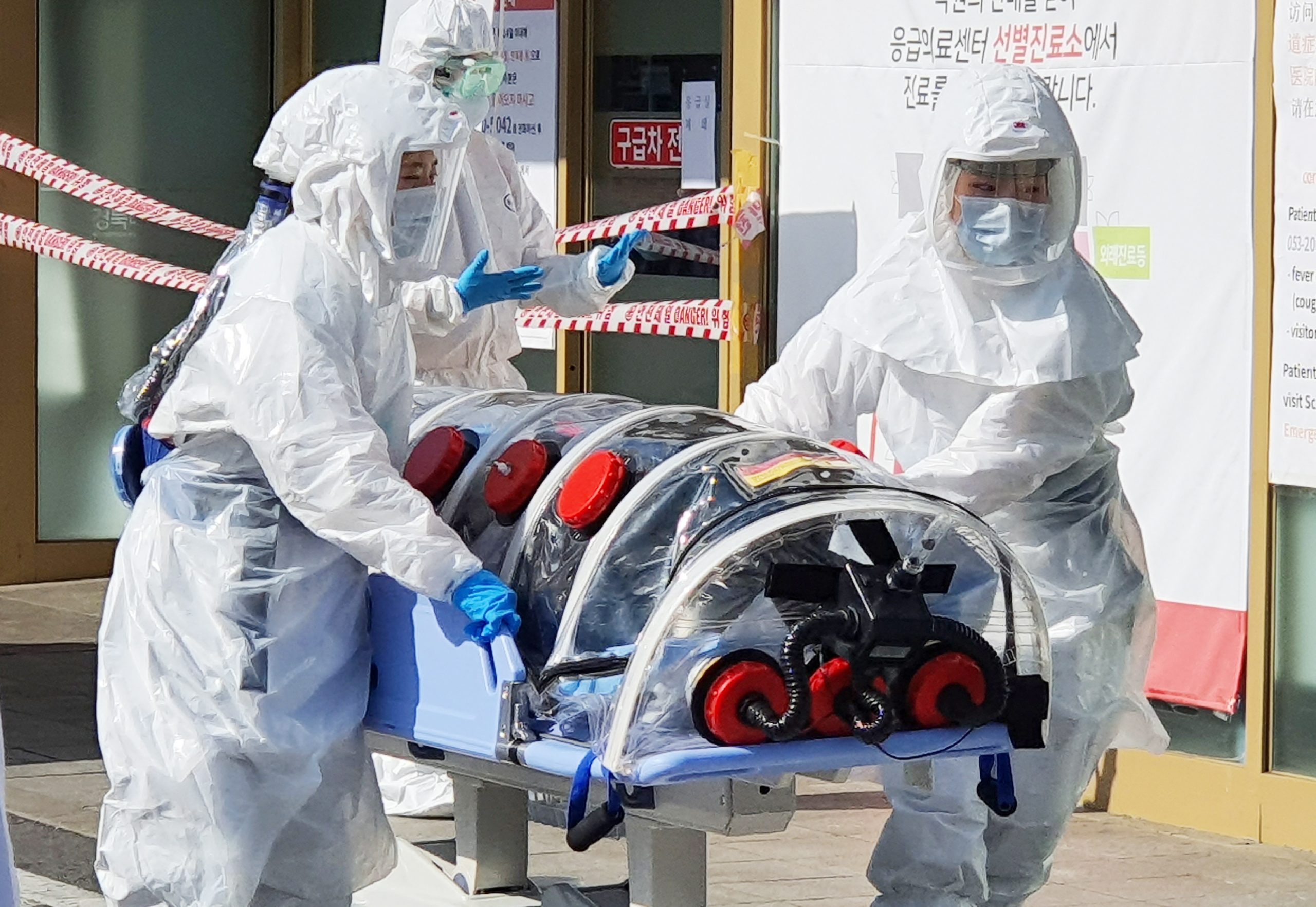 epa08227800 A patient suspected of carrying the new coronavirus, named COVID-19, arrives at Kyungpook National University Hospital in Daegu, South Korea, 19 February 2020. The city fell into chaos as 13 people residing there were found to have come down with the China-originated virus earlier in the day.  EPA/YONHAP SOUTH KOREA OUT