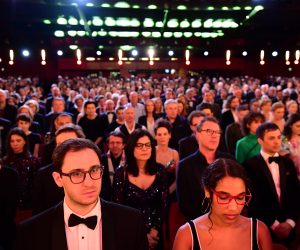 epa08232176 Members of the audience observe a minute of silence for the victims of the Hanau shootings during the Opening Ceremony of the 70th annual Berlin International Film Festival (Berlinale), in Berlin, Germany, 20 February 2020. The Berlinale runs from 20 February to 01 March 2020.  EPA/CLEMENS BILAN