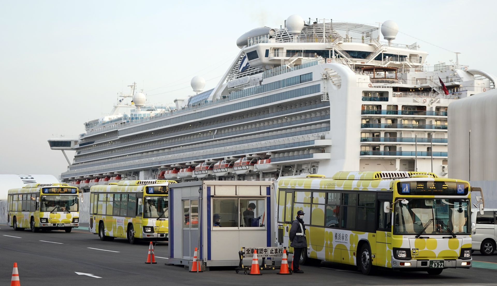 epa08233516 Buses leave the Daikoku Pier Cruise Terminal, where the Diamond Princess cruise ship is docked, in Yokohama, Japan, 21 February 2020. Since 19 February, passengers of the cruise ship have been disembarking, after going through a two-week-long quarantine period following the Covid-19 coronavirus outbreak.  EPA/FRANCK ROBICHON