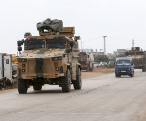 epa08235132 Turkish soldiers and a millitary armored vehicle at the Ad Dana district of north-east Idlib, Syria, 21 February 2020. According to reports, Erdogan said an operation in Syria's Idlib regions was 'imminent'.  EPA/STR