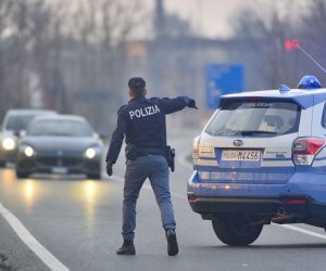 epa08241690 Italian National Police officers stand by as they inform residents at the entrance of the small town of Casalpusterlengo, southeast of Milan, 23 February 2020, under the shadow of a new coronavirus outbreak, as Italy took drastic containment steps as worldwide fears over the epidemic spiralled. Two deaths from the novel coronavirus sparked fears throughout northern Italy as about 50,000 people were poised for a weeks-long lockdown imposed by authorities trying to halt a further increase in infections. Italy on 21 February became the first country in Europe to report the death of one of its own nationals from the virus, triggering travel restrictions on about a dozen towns where the number of people contaminated has continued to rise.  EPA/ANDREA FASANI