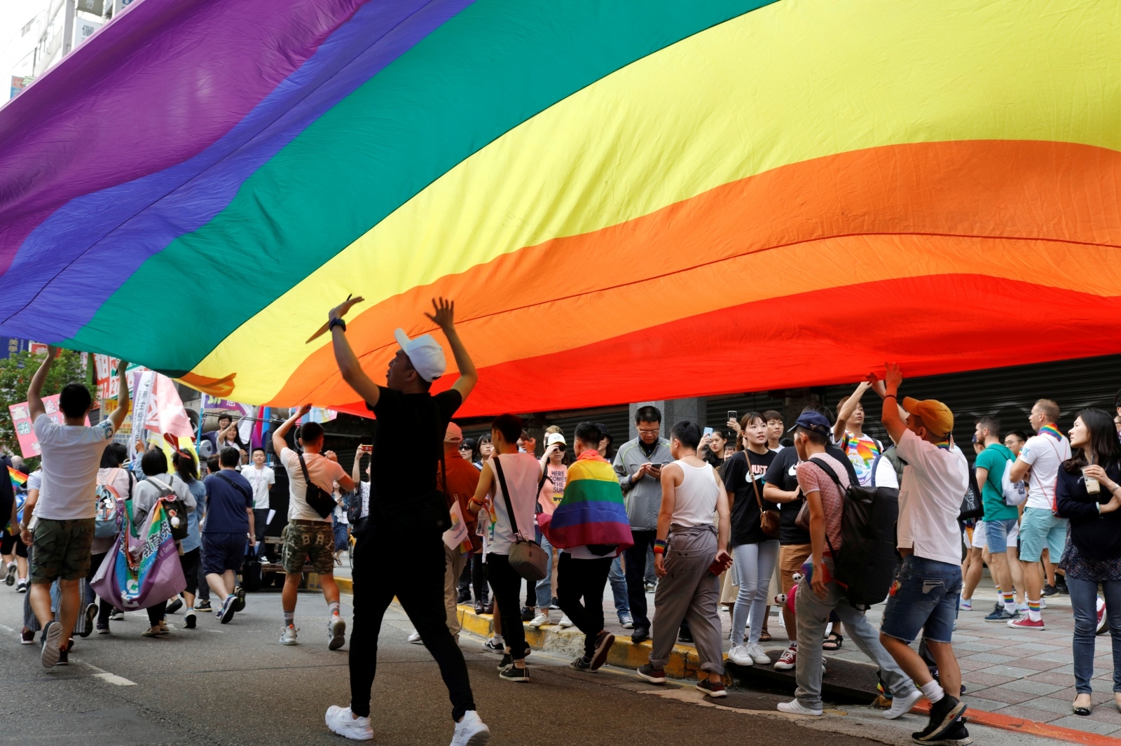 Participants march under a giant rainbow flag during the LGBT Pride parade in Taipei, Taiwan Participants march under a giant rainbow flag during the LGBT Pride parade in Taipei, Taiwan October 26, 2019. REUTERS/Eason Lam EASON LAM