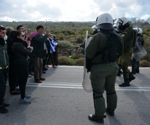 epa08250833 Protesting residents of Mantamados village face riot police forces outside their village, Lesvos Island, Greece, 26 February 2020. People protest against the presence of riot policemen on the island and demand the withdraw of the government plan to construct closed type refugee camp near their village. The Greek islands of Lesbos, Chios, and Samos staged a general strike to protest against the construction of the camps and the police operation.  EPA/PANAGIOTIS BALASKAS