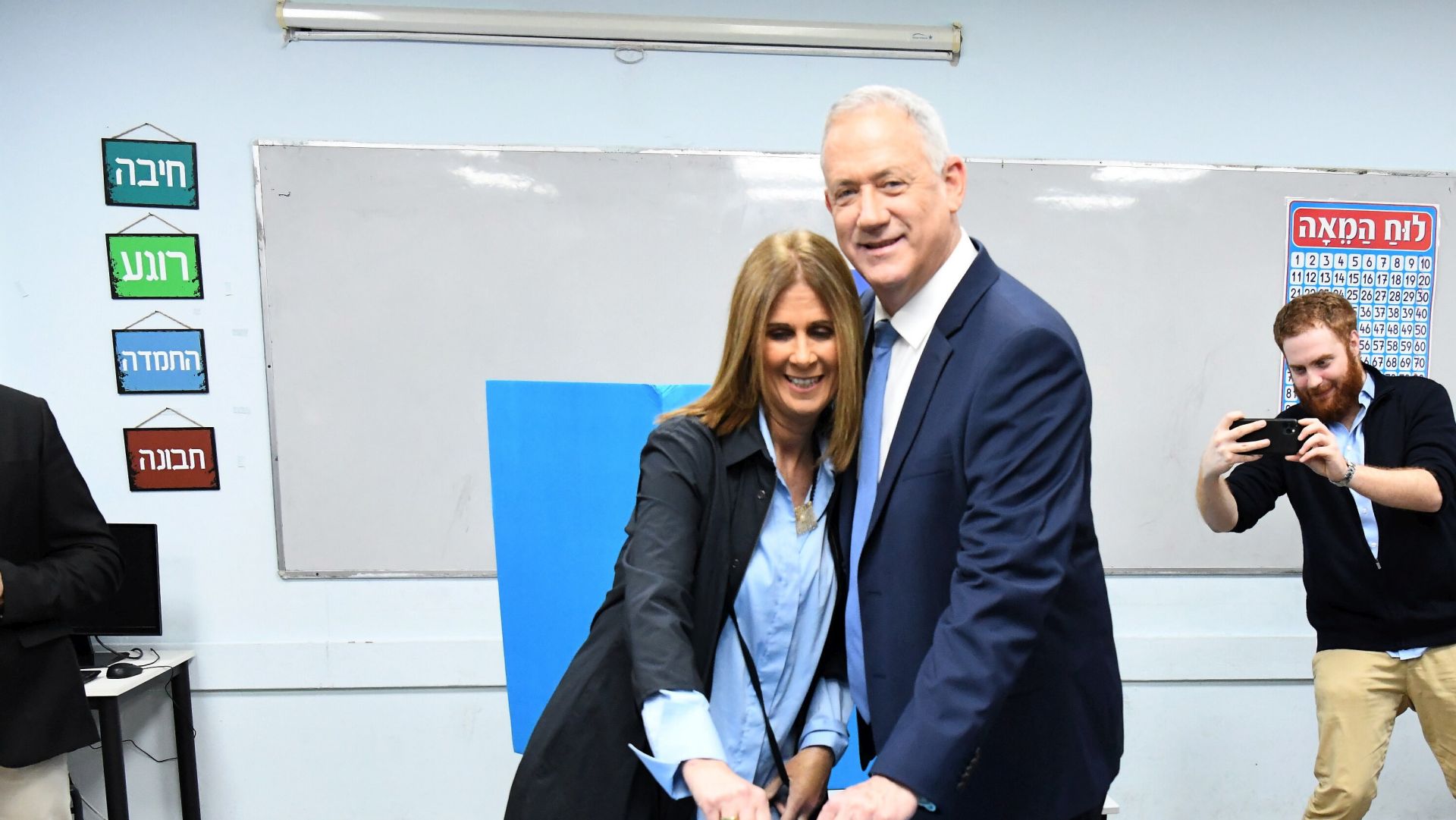 epa08263934 Benny Gantz (C), former Israeli army chief of staff and candidate for prime minister for the Blue and White Israeli centrist political party, and his wife Revital Gantz (L) cast their ballots during the Israeli legislative elections, at a polling station in Rosh Haain, Israel, 02 March 2020. Israelis are heading to the polls for a third general election in less than a year, following the prior elections in April and September to elect the 120 members of the Knesset.  EPA/JINIPIX